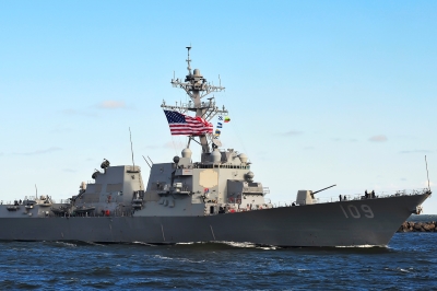 a U.S. Navy ship with an American flag