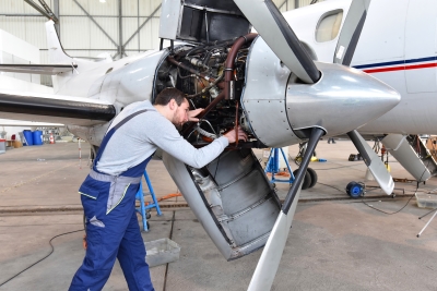 aircraft mechanic repairs an aircraft engine