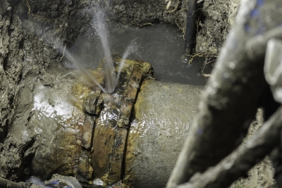 broken asbestos cement pipe leaks water.